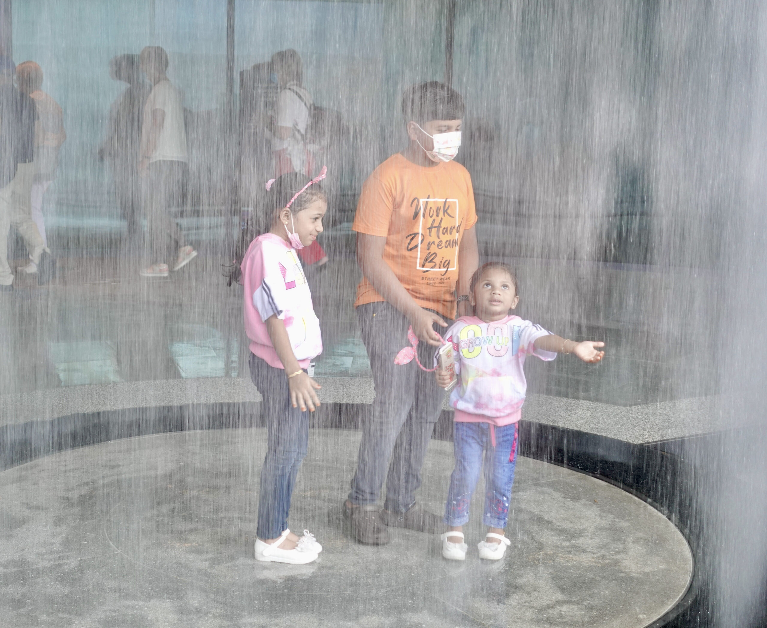 Kids enjoying the artificial waterfall