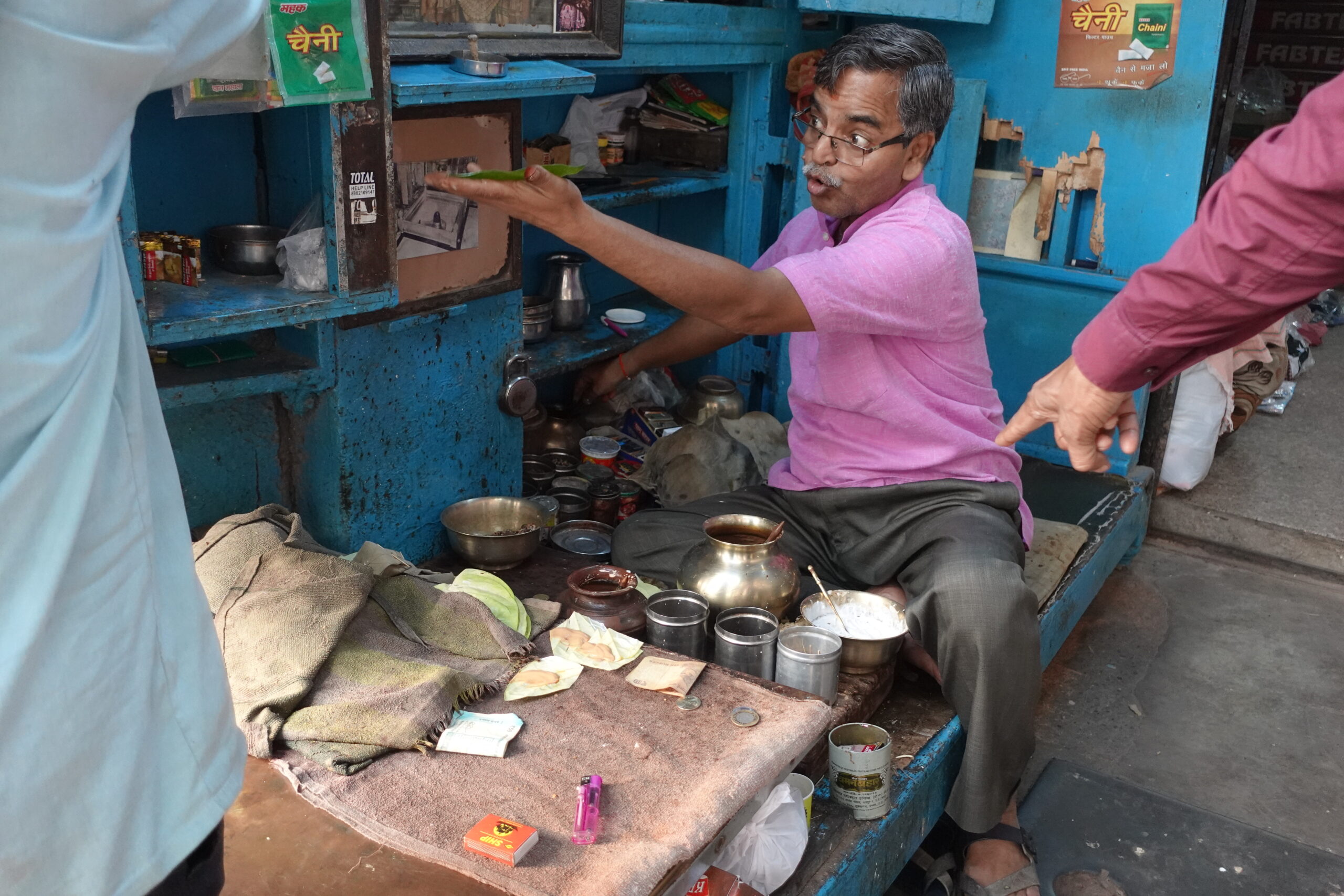 A paan salesman loudly discussing with his customers