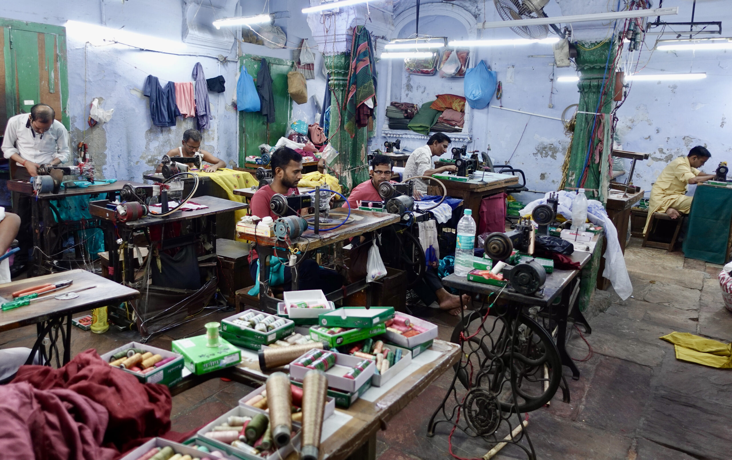 The men in this old haveli are creating beautiful sari accessories