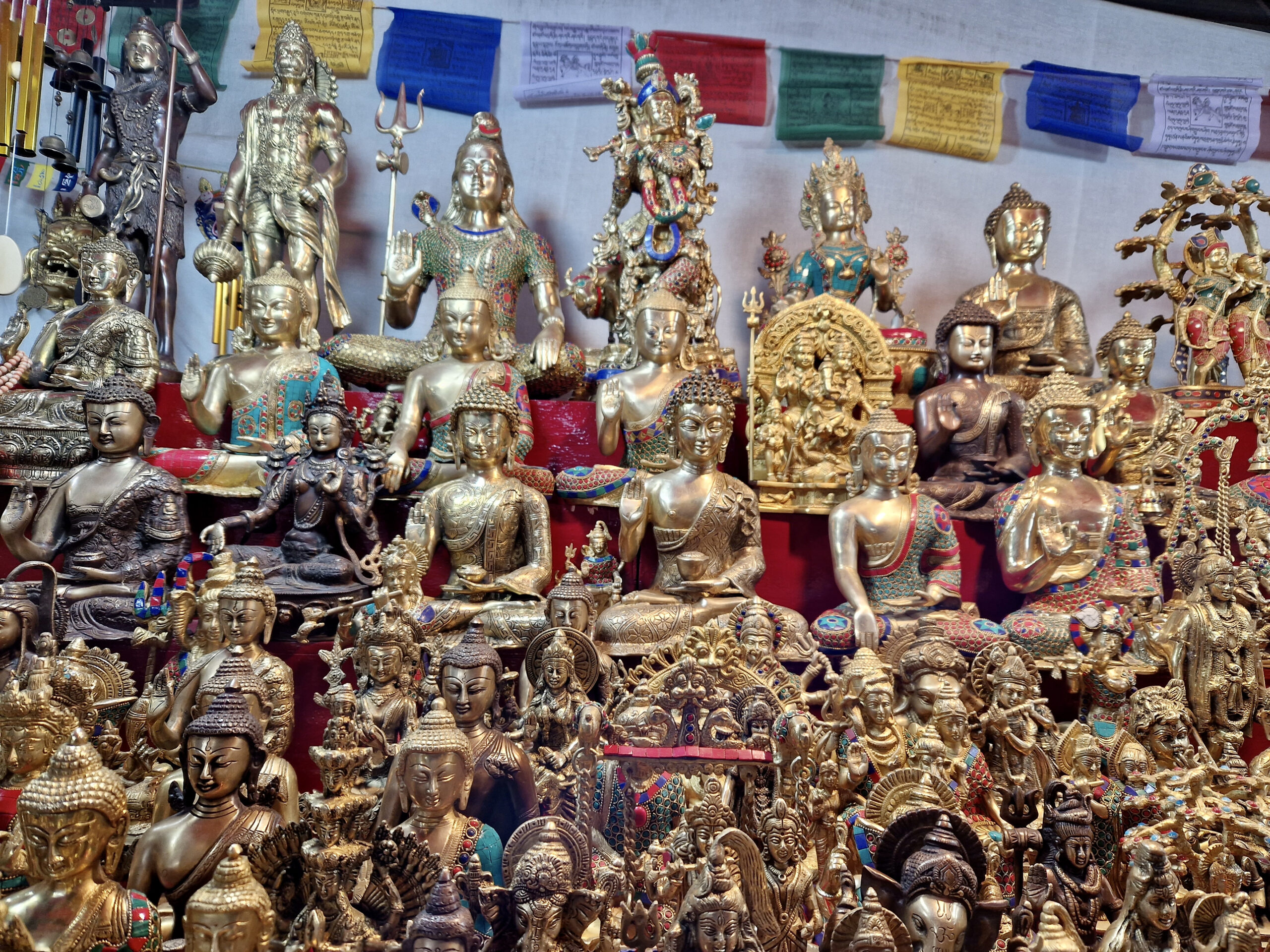 Souvenir stalls offer Buddha statues and prayer flags