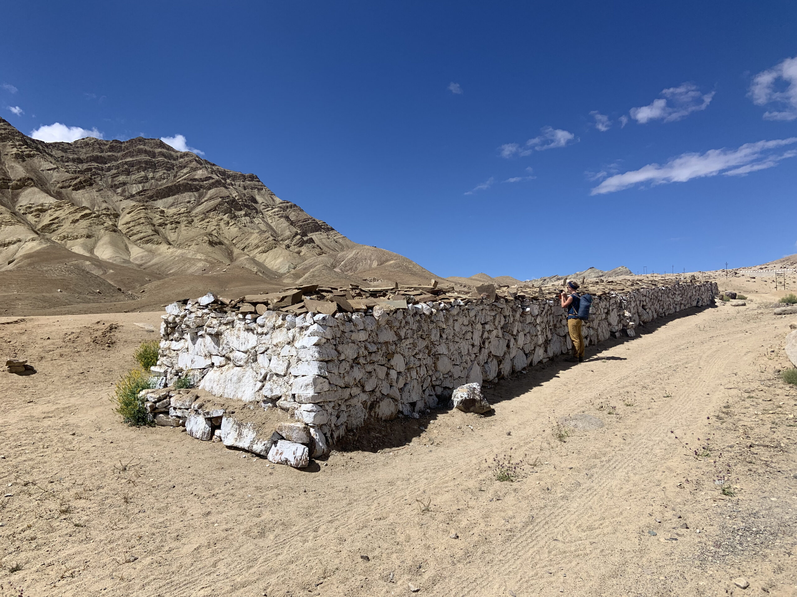 Outside the villages, long walls are built with mani stones on which Buddhist mantras have been engraved